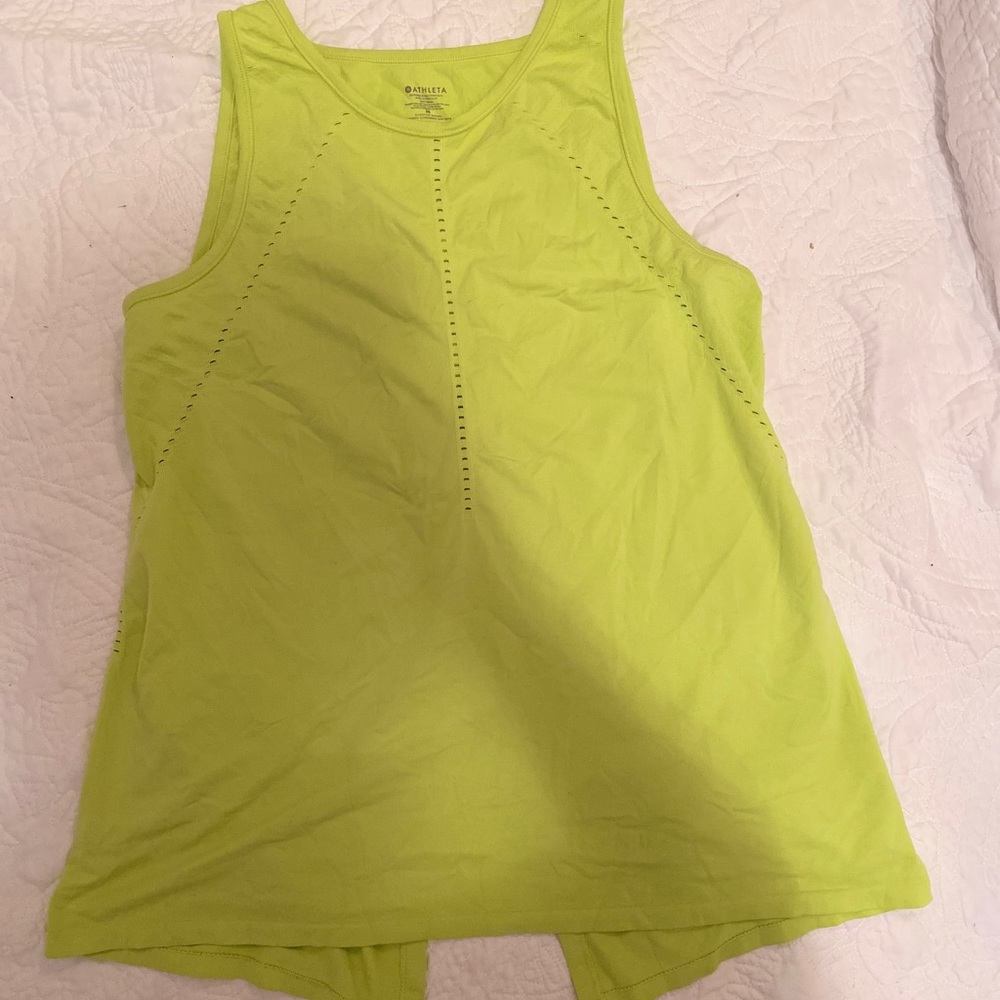 Green tank top with slit in back.
